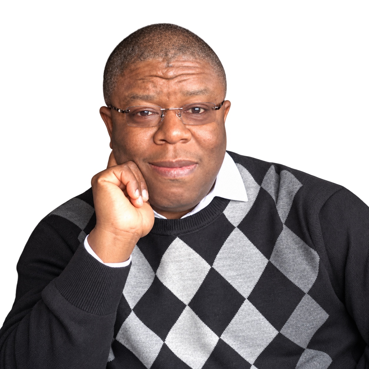 Otunba Olabisi Lateef Ogunlayi wearing glasses and an argyle sweater, with his hand resting against his cheek
